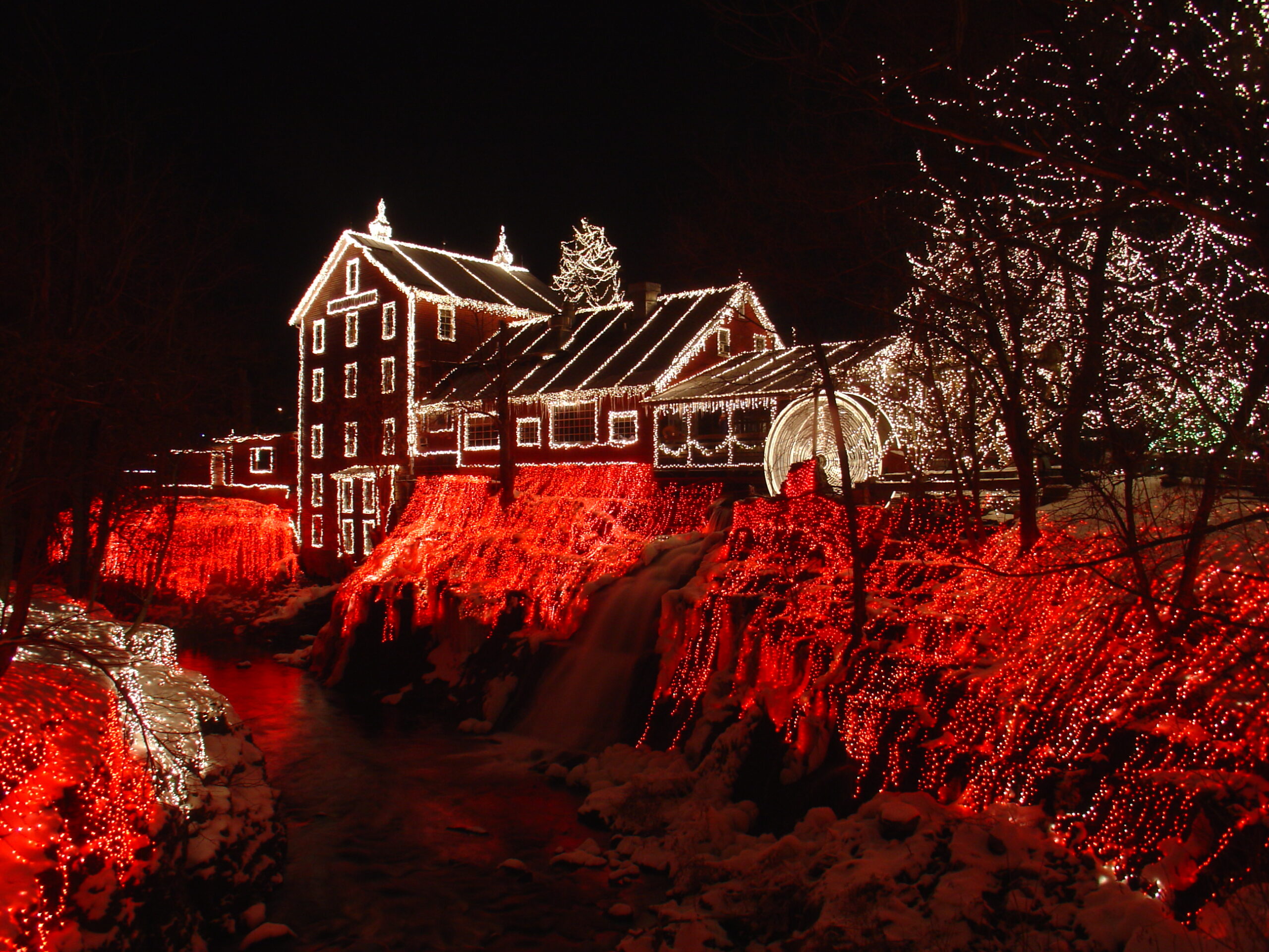 historic mill with christmas lights on hill